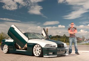Hübscher Mann steht neben seinem edel-getunten BMW Automobil. Beim Fotoshooting mit Fotograf Rainer Rössler